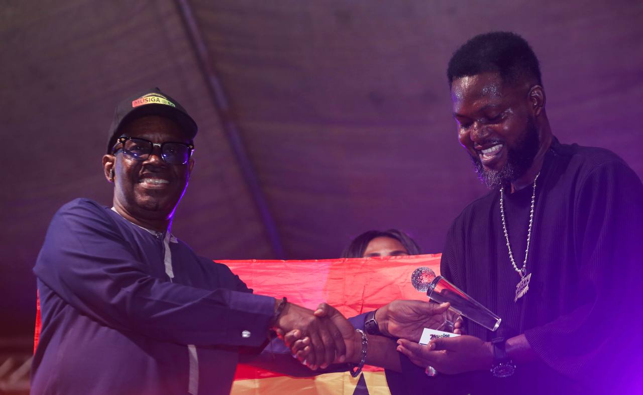 Sparqlyn smiling with trophies